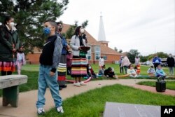 Multi-immersion teacher Randilynn Boucher-Giago addresses students at an assembly at the Red Cloud Indian School in Pine Ridge, S.D., Sept. 30, 2021. Today, the former boarding school operates as a day school.