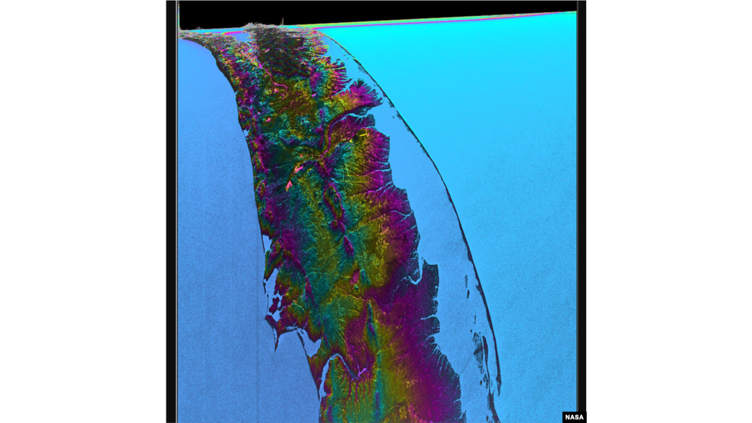 This visualization shows water features on New York’s Long Island – shown as bright pink splotches. Purple, yellow, green, and dark blue shades represent different land elevations, while the surrounding ocean is a lighter blue. (Credit: NASA/JPL-Caltech)