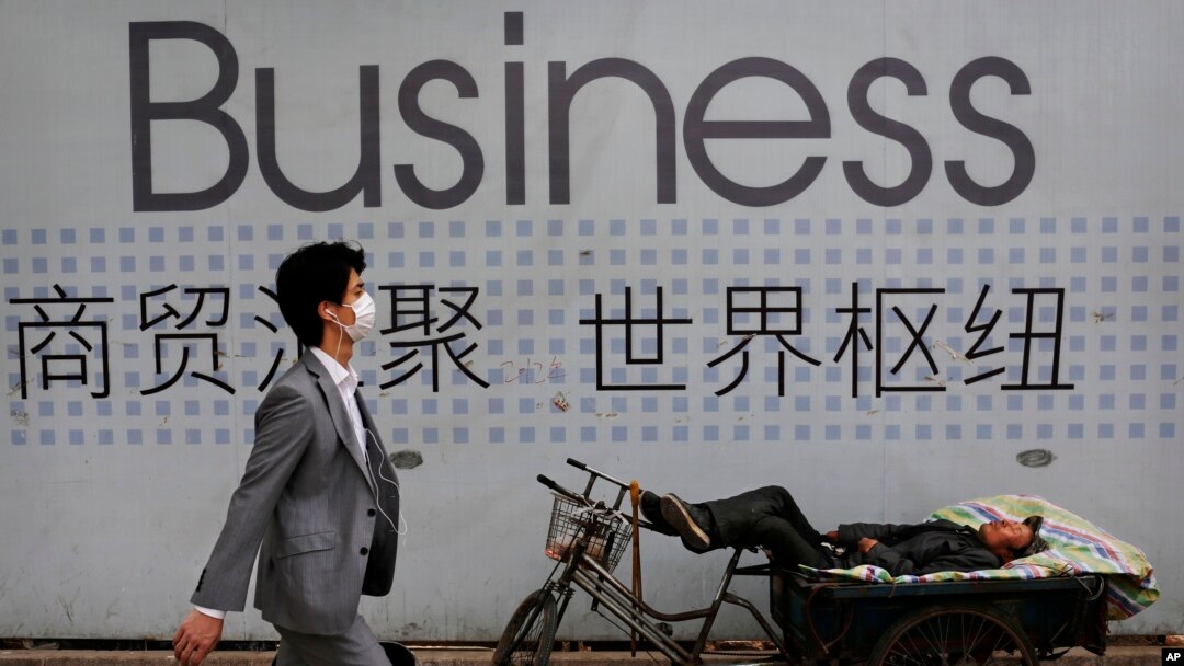 資料照 - 一位中國拉三輪工人在他的三輪車上休息。 背景是一招商廣告。