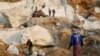 FILE - Workers move pieces of extracted marble from a marble mine in Sagyin, Mandalay, Myanmar, Feb. 15, 2019.