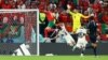 Morocco's Youssef En-Nesyri scores the opening goal against Portugal at the 2022 FIFA World Cup