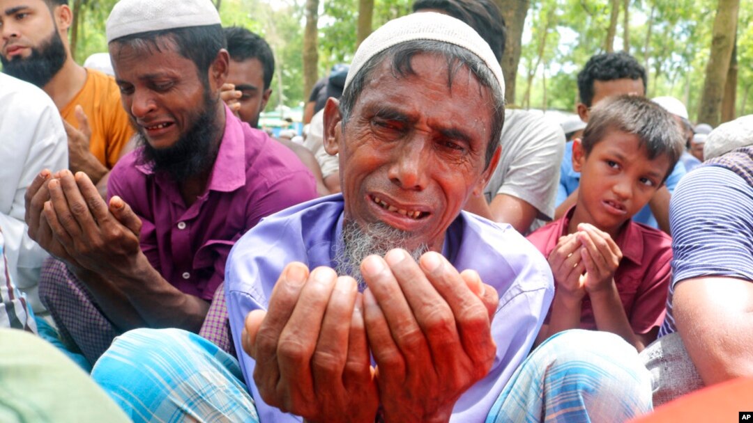 FILE - Rohingya refugees cry while praying during a gathering to mark the fifth anniversary of their exodus from Myanmar to Bangladesh, at a Kutupalong Rohingya refugee camp at Ukhiya in Cox's Bazar district, Bangladesh, Aug. 25, 2022. (AP Photo/ Shafiqur Rahman)
