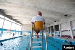 A lifeguard watches over swimmers at the Marville indoor swimming pool which is part of the Marville sports complex, in Saint-Denis, France, July 21, 2017.