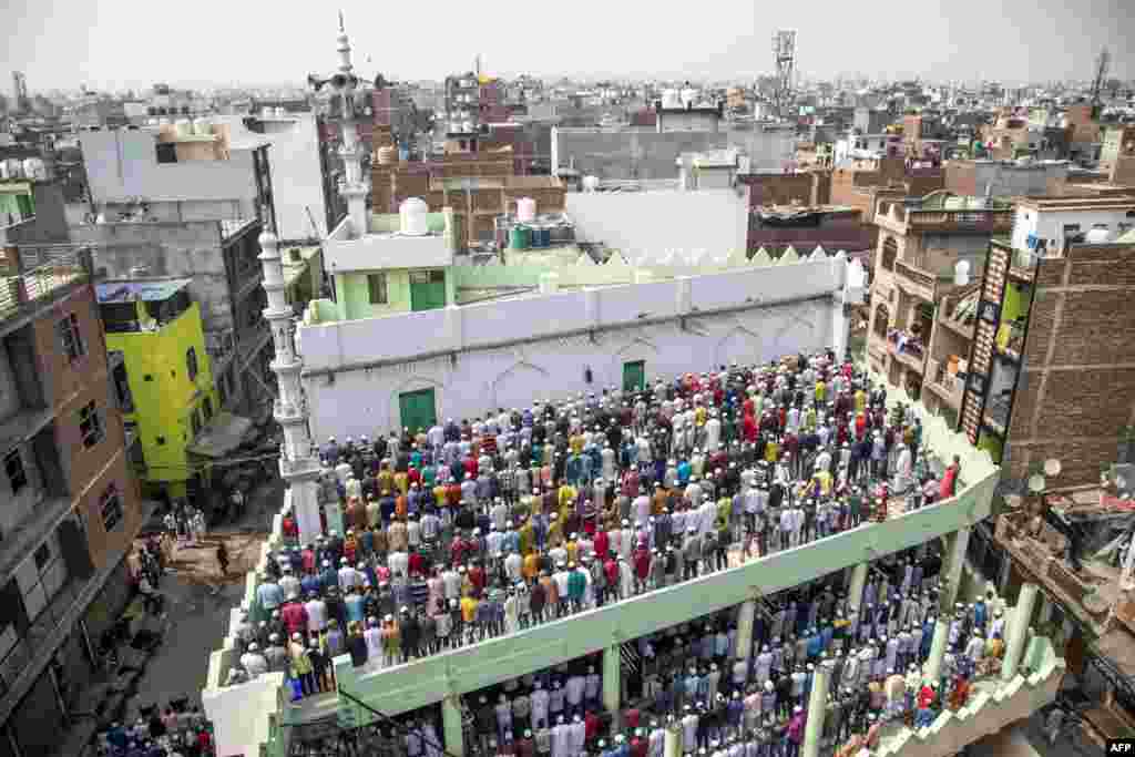 Muslim devotees offer Friday prayers at a mosque following sectarian riots over India's new citizenship law, at Mustafabad area in New Delhi.