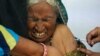 An elderly woman reacts as she is inoculated with the COVID-19 coronavirus vaccine at a government hospital on the outskirts of Ajmer, India, on March 6, 2021.