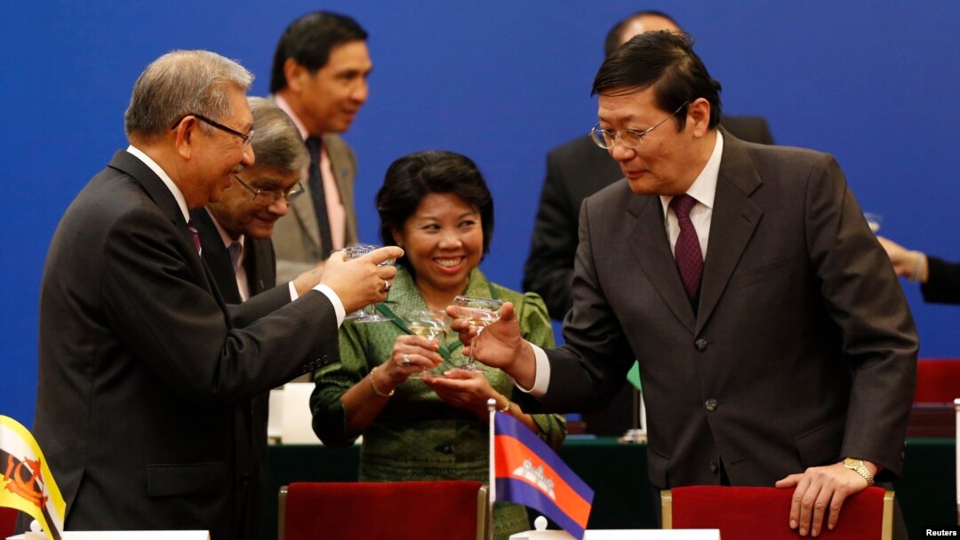 Chinese Finance Minister Lou Jiwei, right, toasts with guests at the signing ceremony of the Asian Infrastructure Investment Bank in Beijing, Oct. 24, 2014. (REUTERS/Takaki Yajima/Pool)