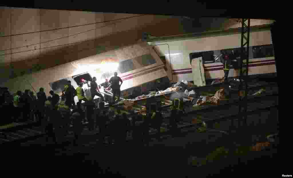 Rescue workers pull victims from a train crash near Santiago de Compostela, Spain, July 24, 2013.