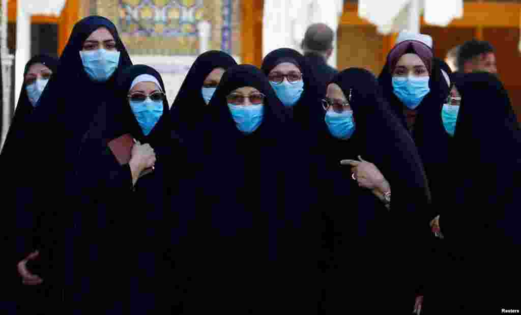 Shi'ite Muslims women wear protective face masks at Imam Ali Shrine, following an outbreak of coronavirus, in the holy city of Najaf, Iraq.
