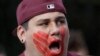 FILE - William Red Bear wears a red hand print image on his face as he marches in support of missing and murdered indigenous women during a rally to mark Indigenous Peoples' Day in downtown Seattle, Washington, Oct. 14, 2019. 