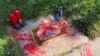 Red painted handprints cover the empty spot at a park in Albuquerque, New Mexico, on Thursday, July 1, 2021, where a historical marker for the Indigenous children who died while attending a boarding school nearby was removed. 