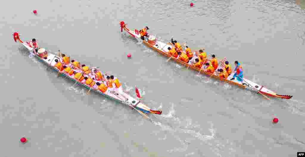 This aerial photo shows teams competing during a dragon boat race ahead of the Dragon Boat Festival in Huaian, in China&#39;s eastern Jiangsu province.