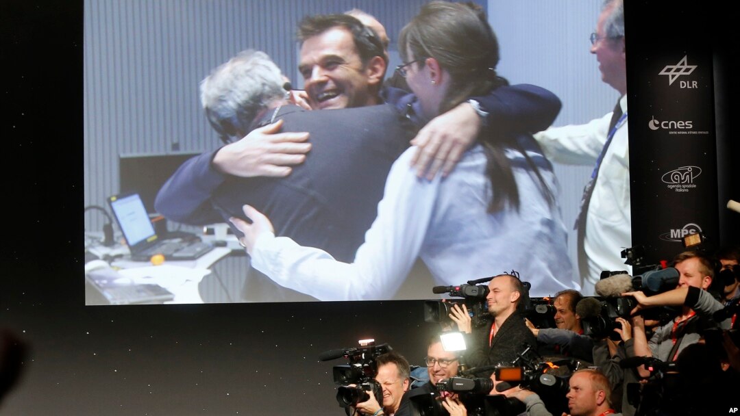 Scientists celebrate at the European Space Agency after the first unmanned spacecraft Philae landed on a comet called 67P/Churyumov-Gerasimenko on Nov. 12, 2014. (AP Photo/Michael Probst)