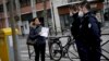 Police officers stop a pedestrian in Boulogne-Billancourt, a western suburb of Paris, France, March 18, 2020.