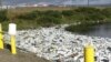Untreated waste and honey bucket bags at the edge of a sewage lagoon in Toksook Bay in Alaska's Bethel Census Area.