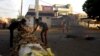 Sudanese protesters erect a barricade along a street during demonstrations in central Khartoum, Sudan, May 15, 2019. 