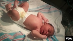 FILE - A chemical that babies give off from their heads calms men but makes women more aggressive, possibly evidence of a chemical defense system we inherited from our animal ancestors, researchers say