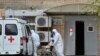 Medical workers wearing protective gear transport a patient suspected of being infected with the coronavirus from an ambulance to a hospital in Rostov-on-Don, Russia, Oct. 22, 2020.