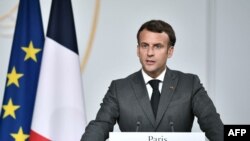FILE - French President Emmanuel Macron speaks during a press conference at the Elysee Presidential Palace, in Paris, July 9, 2021.