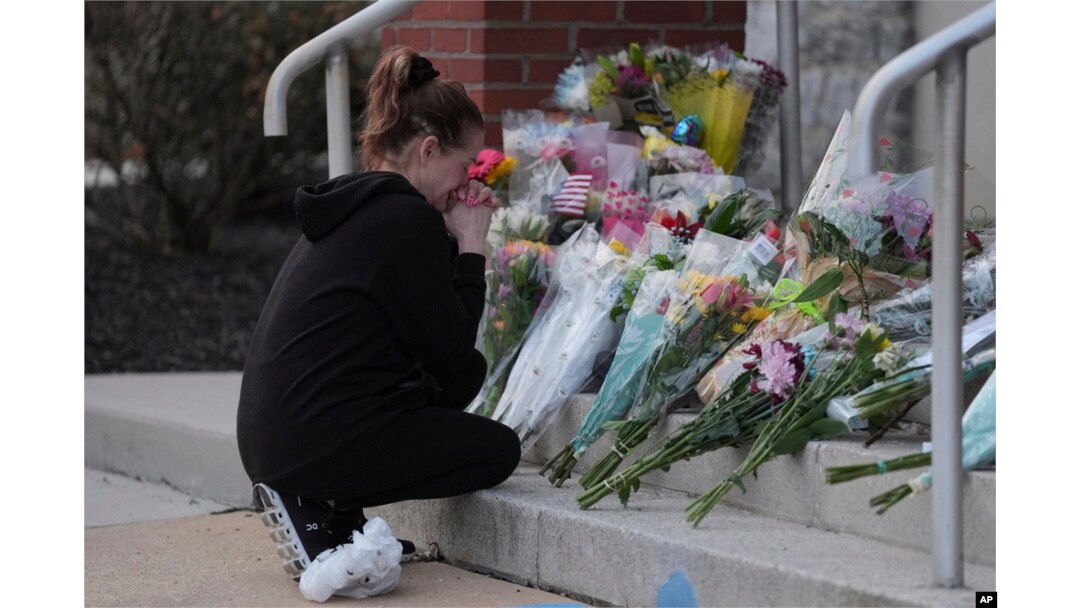 Linda Shields leaves flowers in front of the West York Police Department after a police officer was killed responding to a shooting at UPMC Memorial Hospital in York, Pa., on Feb. 22, 2025.