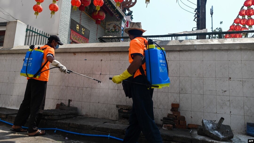 A city government worker disinfects a street as a preventive measure against the COVID-19 coronavirus in Yangon.