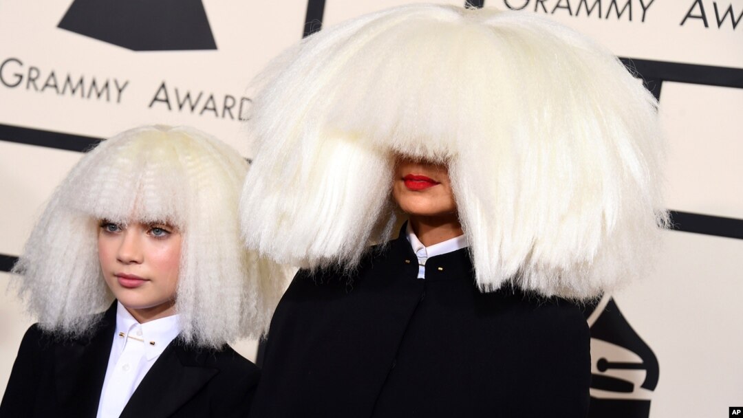 Sia, right, and Maddie Ziegler arrive at the 57th annual Grammy Awards at the Staples Center in Los Angeles, California, Feb. 8, 2015.
