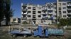 This photograph shows an abandoned playground next to a heavily damaged building in the city of Pokrovsk, Donetsk region, September 24, 2024, amid Russia's invasion of Ukraine.