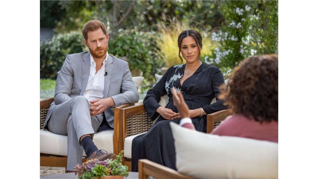 This undated image released March 7, 2021 courtesy of Harpo Productions shows Britain's Prince Harry (L) and his wife Meghan (C), Duchess of Sussex, in a conversation with US television host Oprah Winfrey. - Britain's royal family on March 7, 2021…
