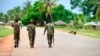 FILE - In this file photo taken March 7, 2018, soldiers from the Mozambican army patrol the streets after security in the area was increased, in Mocimboa da Praia, Mozambique.