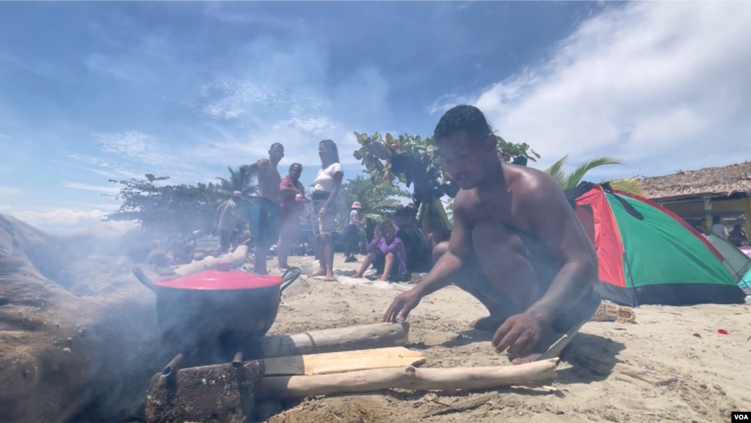 Migrantes, en su mayoría de Venezuela, cocinan en un playa de Necoclí, Colombia, el 11 de octubre de 2022. 