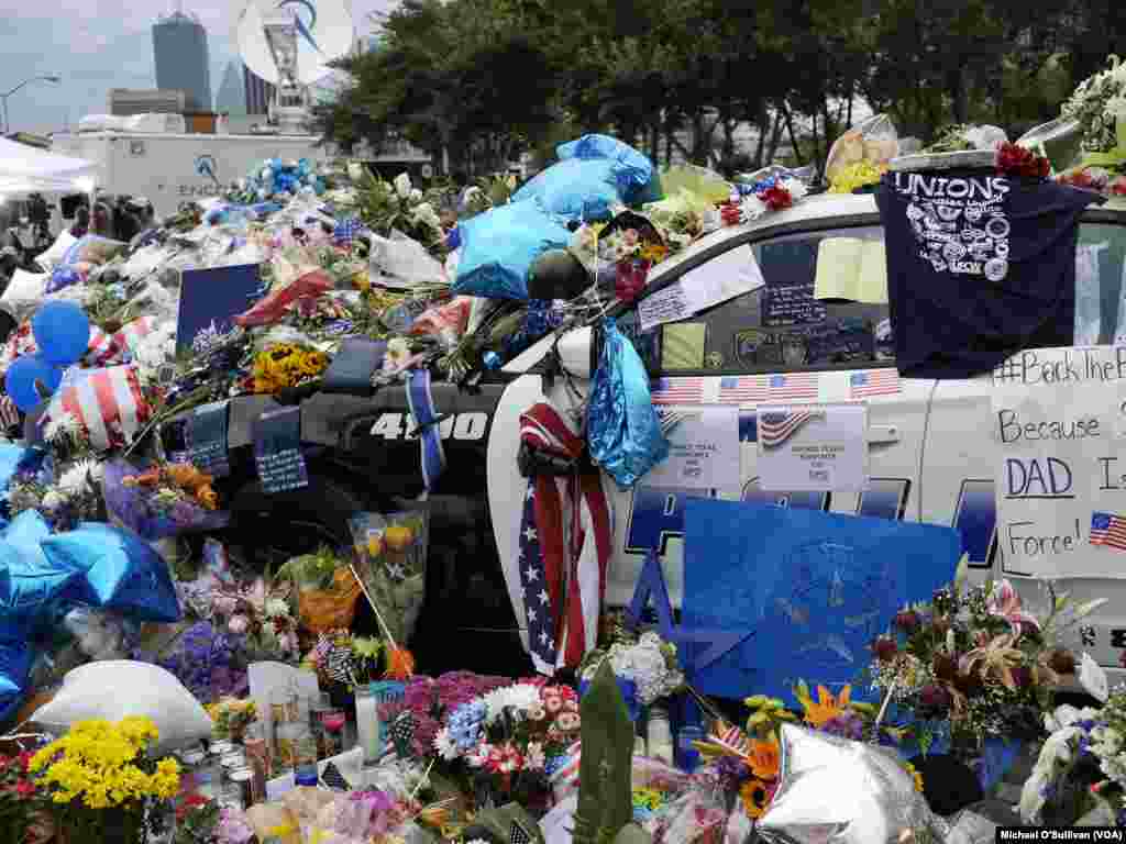 A makeshift memorial outside Dallas police headquarters honoring the officers shot in Thursday night's attack, July 9, 2016.