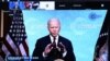 U.S. President Joe Biden is seen on a screen as European Council President Charles Michel attends a virtual Global Climate Summit via video link from the European Council building in Brussels, April 22, 2021.