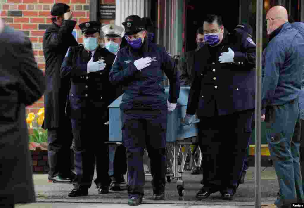 Members of the New York City paramedic community escort the casket of their colleague Anthony "Tony" Thomas in the Bay Ridge area of Brooklyn.