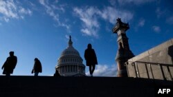 FILE - Visitors walk on the grounds of the US Capitol building in Washington, Jan. 2, 2025.