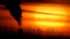 FILE - Emissions from a coal-fired power plant are silhouetted against the setting sun, in Independence, Missouri, Feb. 1, 2021.
