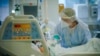 FILE - A health worker treats a COVID-19 patient in the ICU ward at the Hospital das Clinicas in Porto Alegre, Brazil, March 19, 2021. 