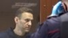 FILE - Law enforcement officers clash with participants during a rally in support of jailed Russian opposition politician Alexey Navalny in Moscow, Russia, Jan. 23, 2021.