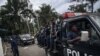 Ba officiers ya polici bazali kobatela gouverneur ya civili ya Nord-Kivu, Carly Nzanzu Kasivita, nsima ya bozwami ya bokonzi ya General Constant Ndima bo' gouverneur militaire, Goms. o'mokolo mwa 10 mai 2021 engebene na etat de siege. (Photo AFP/ALEXIS HUGUET)