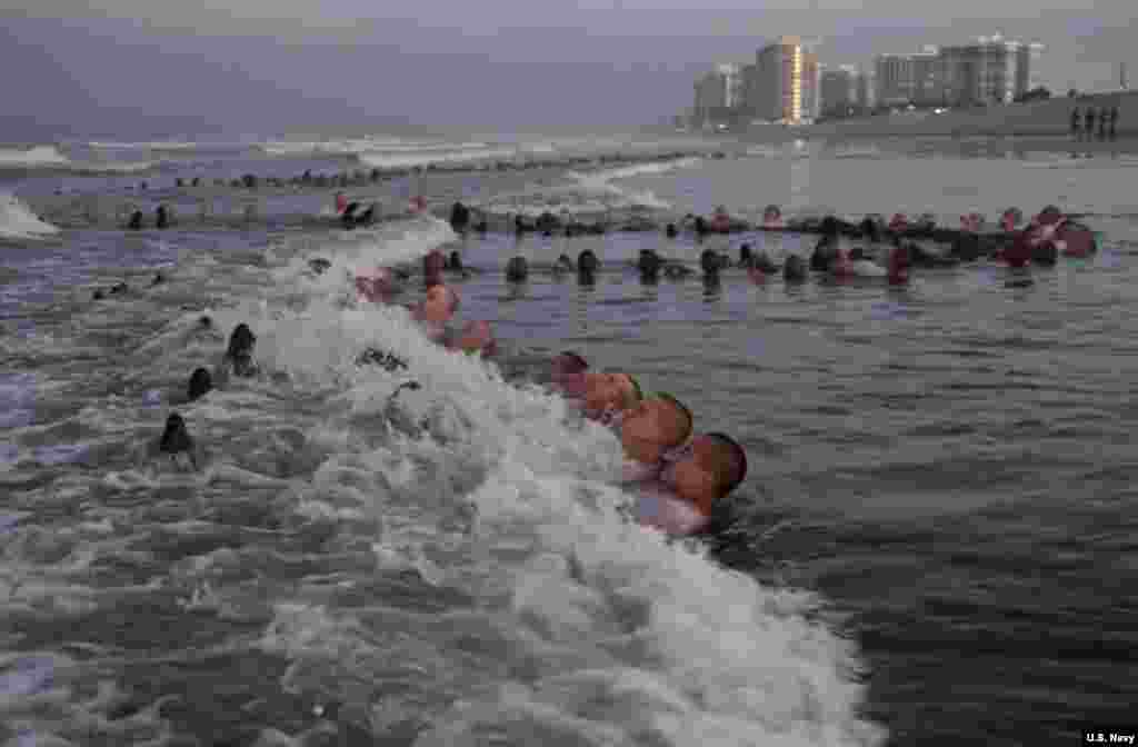 SEAL candidates participate in surf immersion during Basic Underwater Demolition/SEAL (BUD/S) training at Naval Special Warfare (NSW) Center in Coronado, California, May 4, 2020.