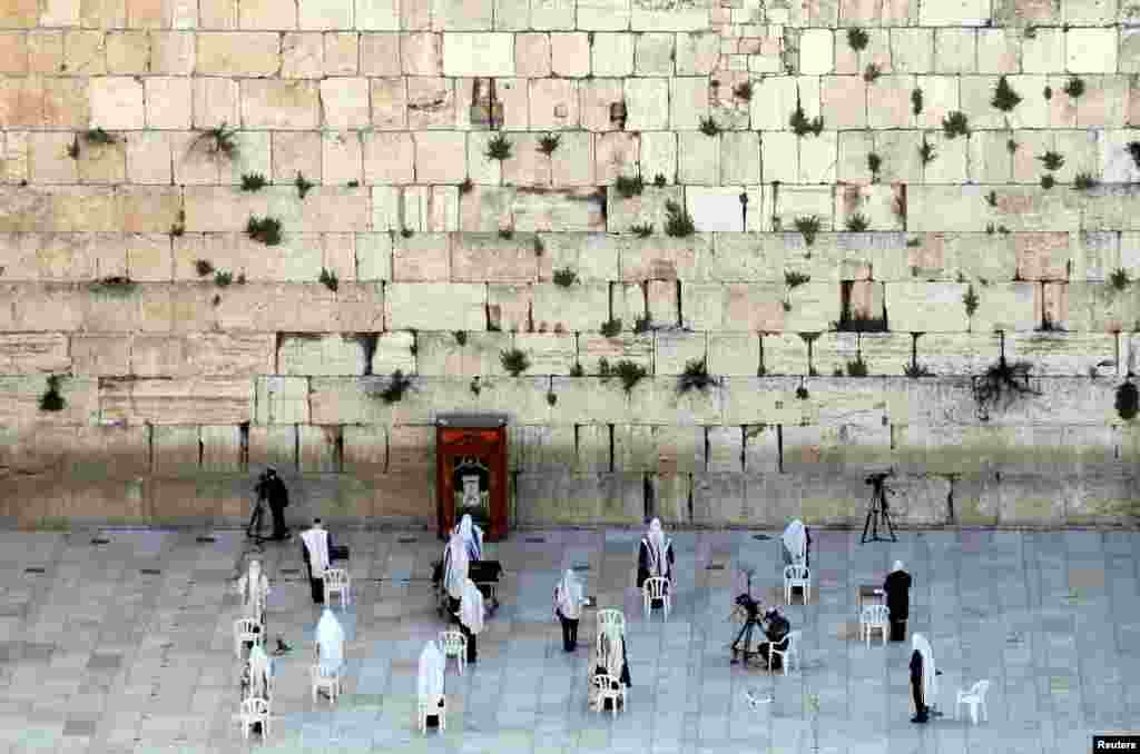 A small number of Jewish worshipers pray during the priestly blessing, a traditional prayer which usually attracts thousands of worshipers at the Western Wall on the holiday of Passover, amid the coronavirus disease (COVID-19) outbreak, in Jerusalem's Old City.