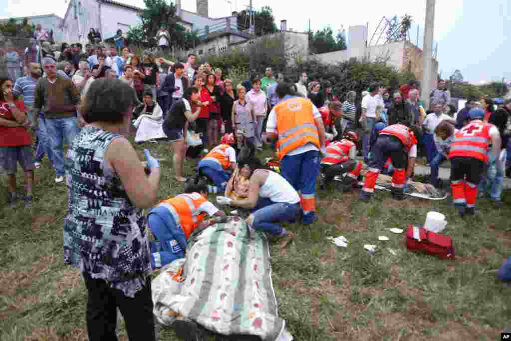 Emergency personnel treat survivors after a train derailment in Santiago de Compostela, Spain, July 24, 2013.