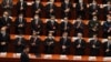 Los delegados que usan máscaras para ayudar a frenar la propagación del coronavirus aplauden cuando el presidente chino, Xi Jinping, llega a la sesión de apertura del Congreso en el Gran Salón del Pueblo, el 4 de marzo de 2021. 