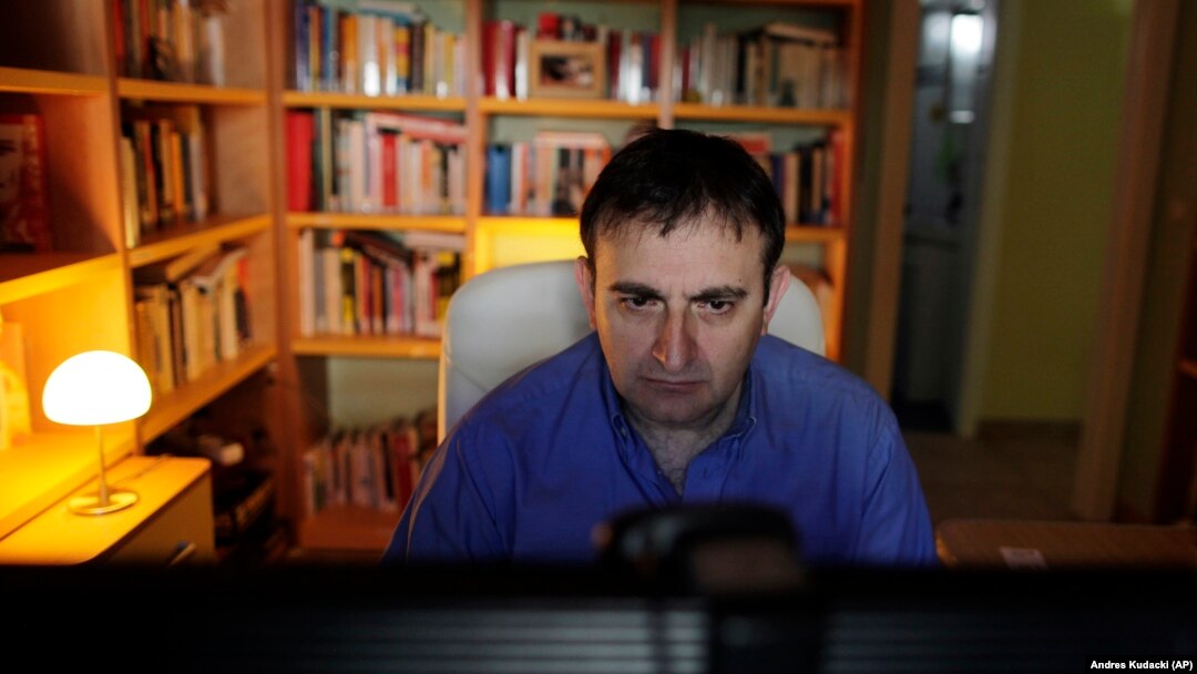 In this May 24, 2013 file photo, student Raul Ramos goes through his online homework during an internet-based, college-level class in Madrid, Spain.